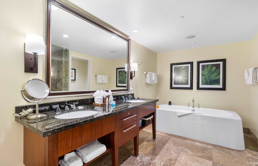 The luxurious master bath offers a double granite vanity
